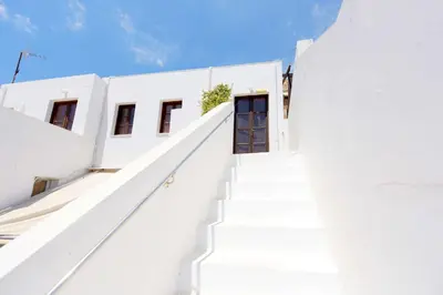 a staircase leading up to a white building with a door at Teresa's Home in Líndos
