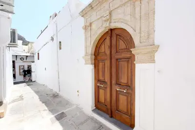 a wooden door on the side of a building at Teresa's Home in Líndos