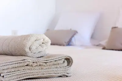 a pile of towels sitting on top of a bed at Teresa's Home in Líndos