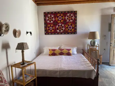 a bedroom with a bed and a painting on the wall at Teresa's Home in Líndos