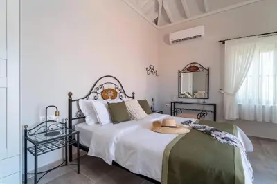a bedroom with a bed with a hat on it at Muse Clio in Halki