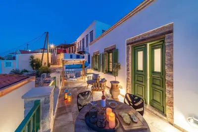 a patio with a table and chairs on a building at Muse Clio in Halki