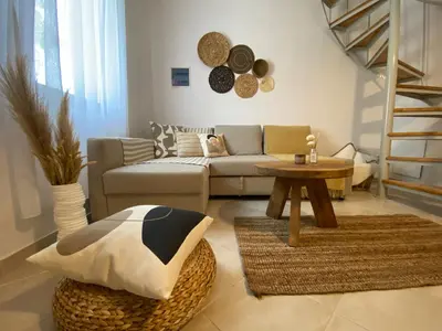 a living room with a couch and a table at Celestia Apartments in Halki