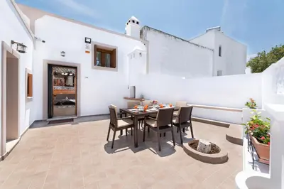 a patio with a table and chairs on a balcony at Traditional House Leventis in Archangelos