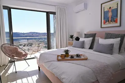 a bedroom with a large bed and a large window at Villa Vitabel sea view in Lindos in Líndos