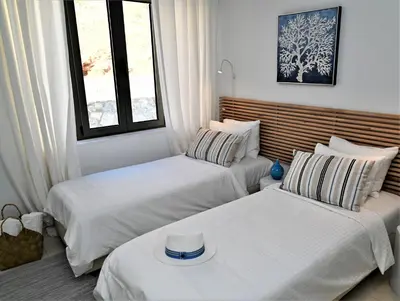 a room with two beds and a couch and a window at Villa Vitabel sea view in Lindos in Líndos