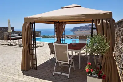 a gazebo with a table and chairs on a patio at Villa Vitabel sea view in Lindos in Líndos