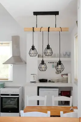 a kitchen with three lights hanging from the ceiling at Elia Suites in Triánta