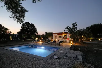 a swimming pool in the middle of a yard at Elia Suites in Triánta