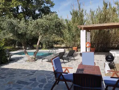 a patio with chairs and a swimming pool at Elia Suites in Triánta