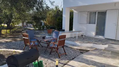 a patio with a table and chairs in front of a house at Elia Suites in Triánta
