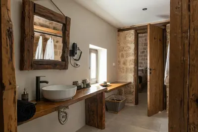 a bathroom with a sink and a mirror at Ancient Knights Luxury Suites in Rhodes Town