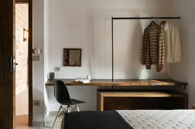 a bedroom with a desk and a chair next to a bed at Ancient Knights Luxury Suites in Rhodes Town