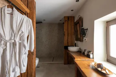 a bathroom with a wooden vanity and a sink at Ancient Knights Luxury Suites in Rhodes Town