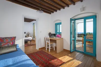 a bedroom with a bed and a desk with a table at Villa Mary's Holiday House in Pefki Rhodes