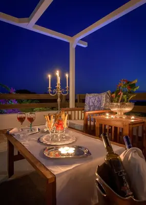 a table with wine glasses and a bottle of wine at Villa Mary's Holiday House in Pefki Rhodes