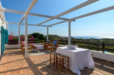 a patio with tables and chairs on a roof at Villa Mary's Holiday House in Pefki Rhodes
