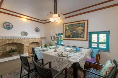 a dining room with a table and a fireplace at Villa Mary's Holiday House in Pefki Rhodes