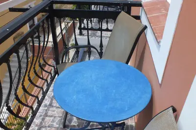 a blue table and chairs on a balcony at Anastasia Apartments (Chorio) in Symi
