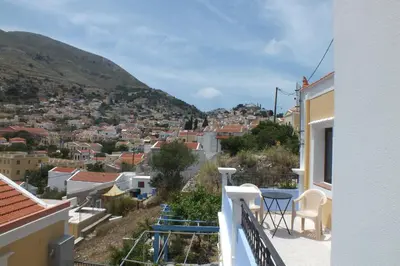 a balcony with a view of a city at Anastasia Apartments (Chorio) in Symi