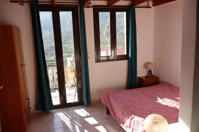 a bedroom with a bed and a window at Anastasia Apartments (Chorio) in Symi