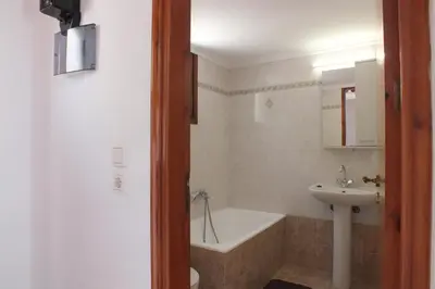 a bathroom with a tub and a sink and a bath tub at Anastasia Apartments (Chorio) in Symi