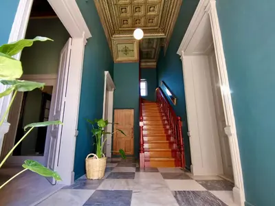 a hallway with blue walls and a staircase at 1900 Hotel in Symi