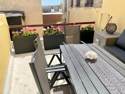 a table and chairs on a balcony with flowers at Rhodes Old Town Harmony Suite in Rhodes Town