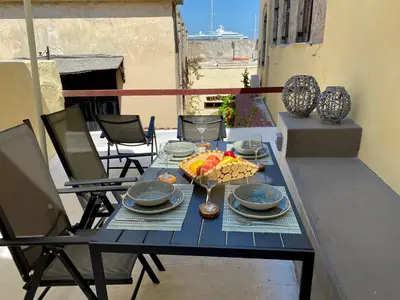 a blue table with food on top of a balcony at Rhodes Old Town Harmony Suite in Rhodes Town