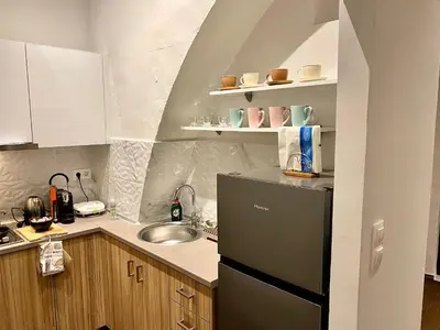 a small kitchen with a sink and a refrigerator at Rhodes Old Town Harmony Suite in Rhodes Town