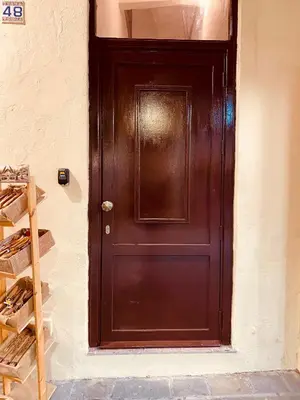 a brown door in a wall with a shelf at Rhodes Old Town Harmony Suite in Rhodes Town