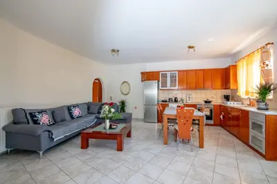 a living room with a couch and a table at Rodini Sun Apartment in Rhodes Town
