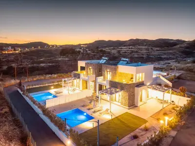 an aerial view of a house with two swimming pools at Kiotari Fresh in Kiotari