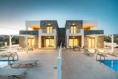 a resort with a pool and chairs and a building at Kiotari Fresh in Kiotari