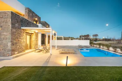 a backyard with a swimming pool and a house at Kiotari Fresh in Kiotari