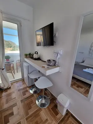 a room with a desk and a bed and a mirror at 12 senses faliraki sea view in Faliraki