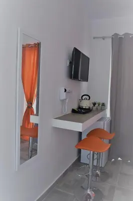 a room with a counter and a mirror and a stool at 12 senses faliraki sea view in Faliraki