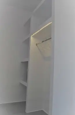a white walk in closet with white shelves at 12 senses faliraki sea view in Faliraki
