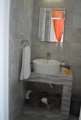 a bathroom with a sink and a mirror at 12 senses faliraki sea view in Faliraki