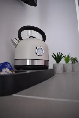 a tea kettle sitting on top of a kitchen counter at 12 senses faliraki sea view in Faliraki