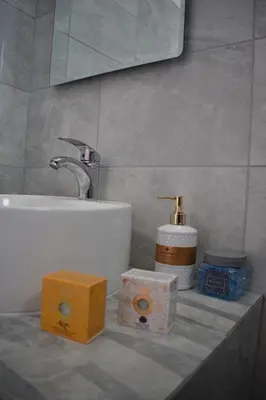 a bathroom with a sink and two boxes on a counter at 12 senses faliraki sea view in Faliraki