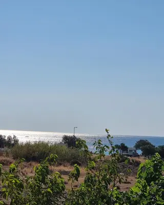 a view of a beach with the ocean in the background at 12 senses faliraki sea view in Faliraki