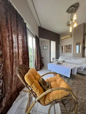 a room with a table and chairs and a bed at Appartment by the beach in Rhodes Town