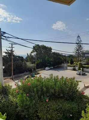 a view of a parking lot with cars parked at Appartment by the beach in Rhodes Town
