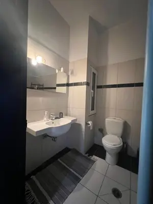 a bathroom with a sink and a toilet at Appartment by the beach in Rhodes Town