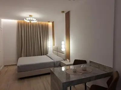 a hotel room with a bed and a table at POUNEDES LUXURY SUITES in Pefki Rhodes