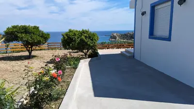 a walkway leading to a house with a view of the ocean at KIRA'S RESIDENCE PANORAMIC VIEW in Archangelos