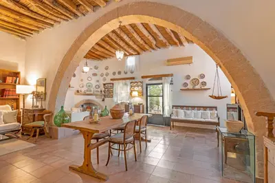 a living room with an archway and a table and chairs at Hidden Gem of Afandou , Traditional House & Patio in Afantou