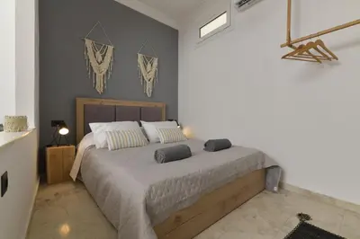 a bedroom with a large bed in a room at Centrale Apartment Symi in Symi
