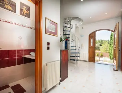 a hallway with a staircase in a house at Butterfly Garden Villa in Pastida